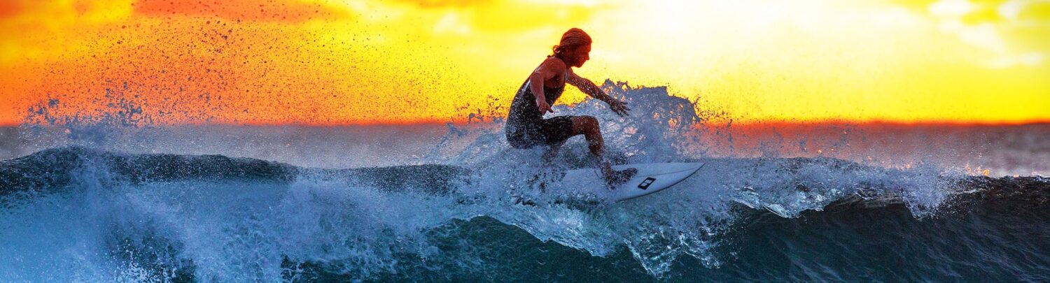 surfer-on-the-ocean-wave-during-the-sunset